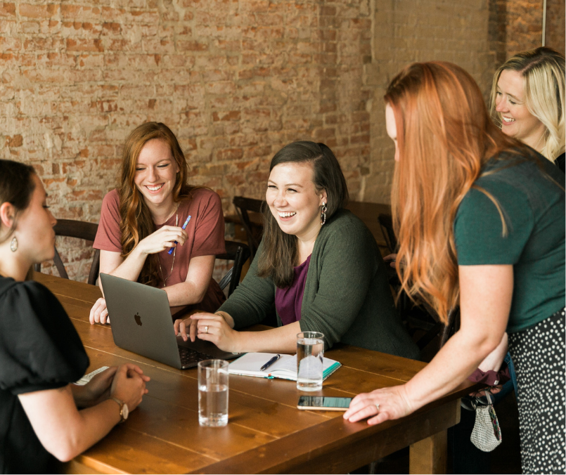 Business women working at a desk smiling