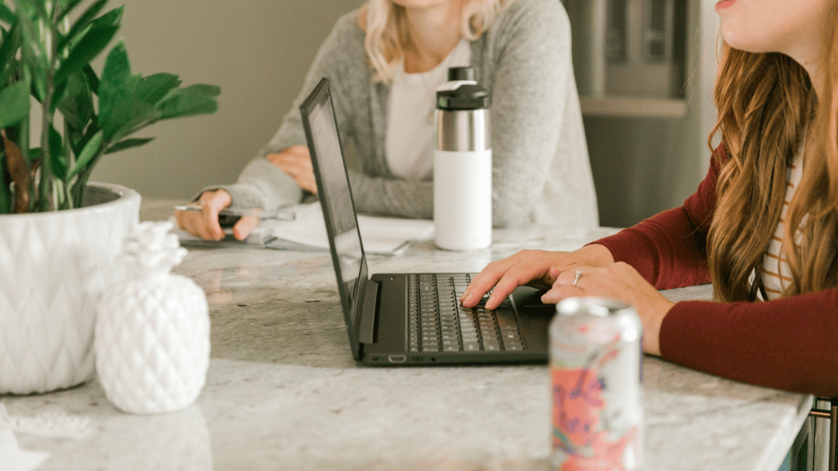 Business women working at a desk smiling